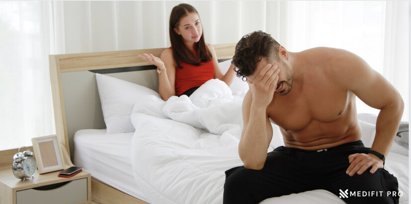 A man embarrassed in bed due to erectile dysfunction Medifitpro.com